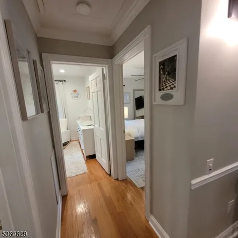 a living room with furniture a flat screen tv and wooden floor