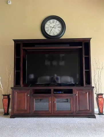 a living room with a flat screen tv and a fireplace