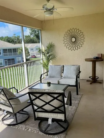 a view of a balcony with furniture