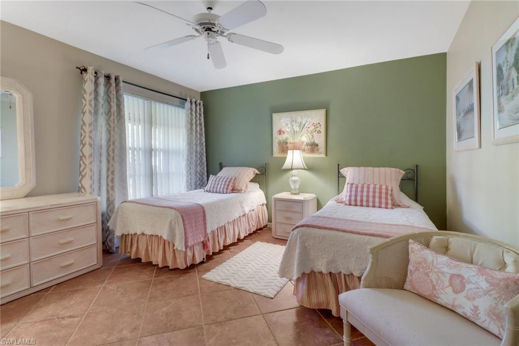 11745 Quail Village Way Naples, FL 34119 - Photo 11 of 24 Tiled bedroom with ceiling fan