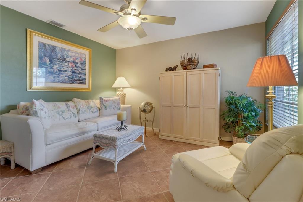 11745 Quail Village Way Naples, FL 34119 - Photo 12 of 24 Living room featuring ceiling fan and light tile patterned floors