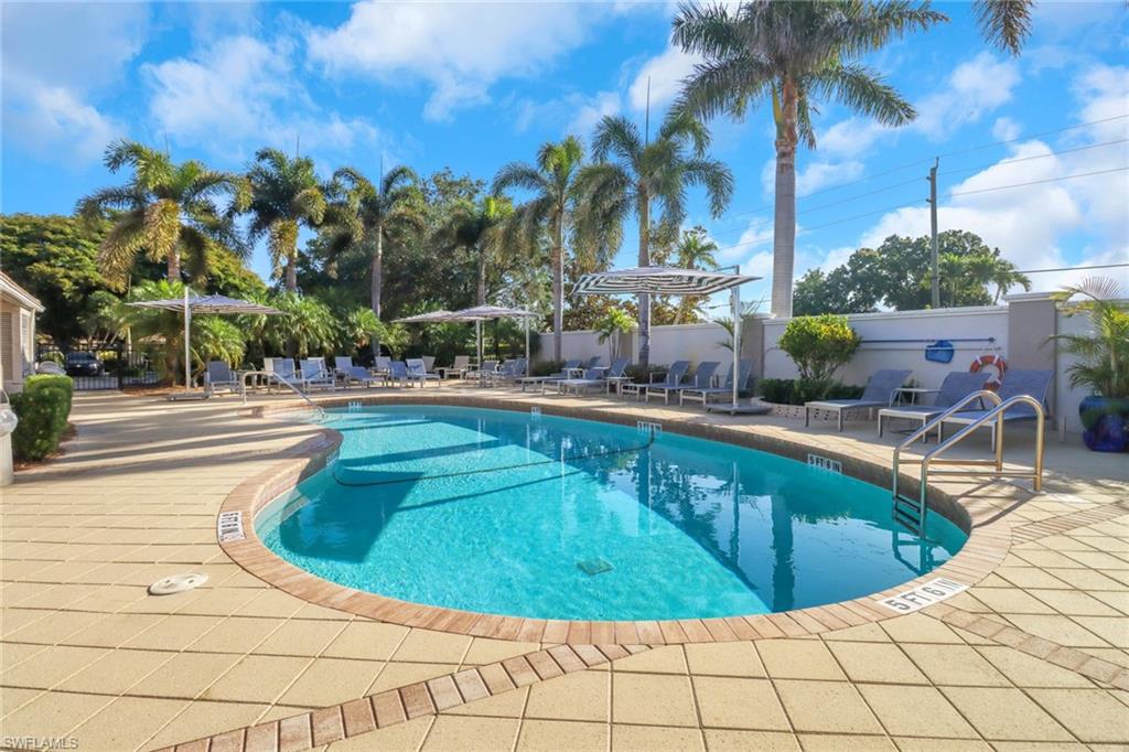11745 Quail Village Way Naples, FL 34119 - Photo 19 of 24 Community pool with a patio area