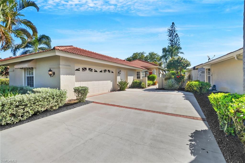 11745 Quail Village Way Naples, FL 34119 - Photo 2 of 24 View of front of house featuring a garage