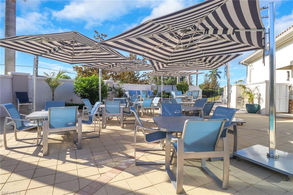11745 Quail Village Way Naples, FL 34119 - Photo 21 of 24 Fenced backyard featuring outdoor dining space and a patio area