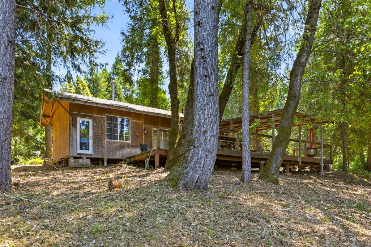 19643 Sages Road Nevada City, CA 95959 - Photo 3 of 39 a view of a house with a tree in the forest