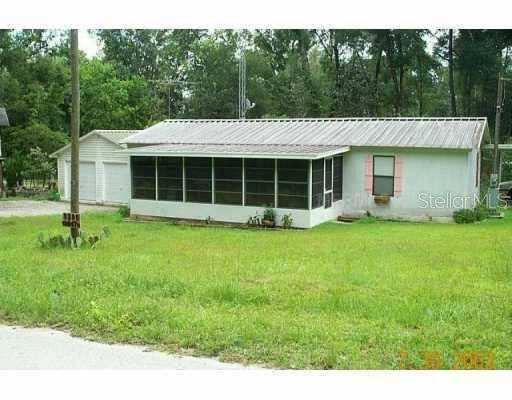 9399 Cr 647 Road Bushnell, FL 33513 - Photo 1 of 1 a view of a house with backyard and a garden