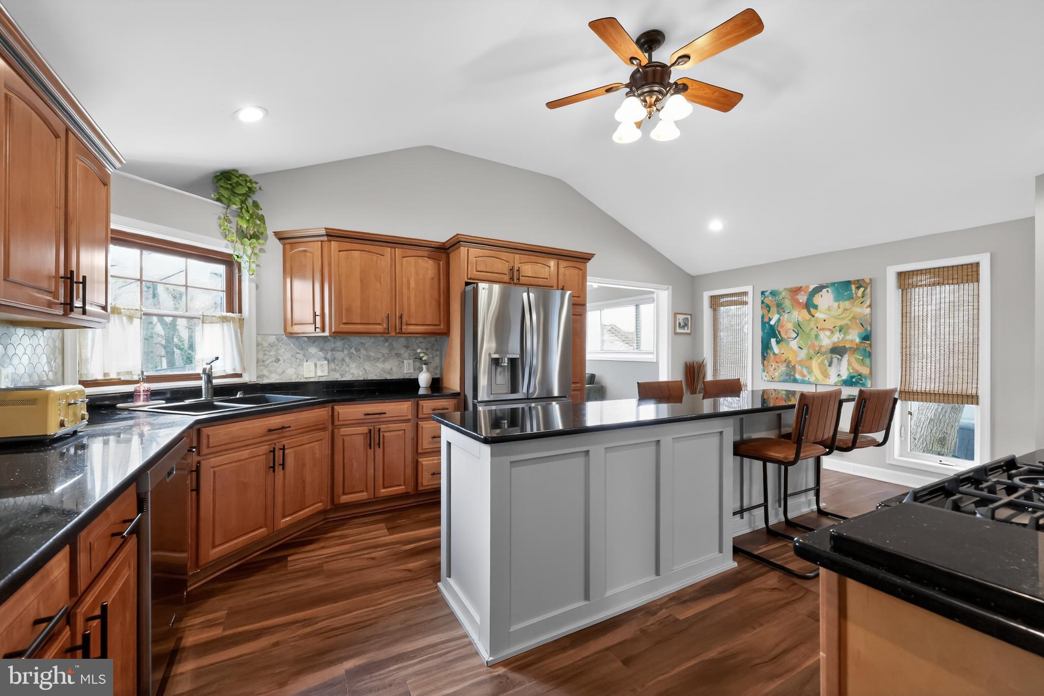 208 Richey Avenue Collingswood, NJ 08107 - Photo 12 of 35 a kitchen with granite countertop cabinets a dining table and chairs