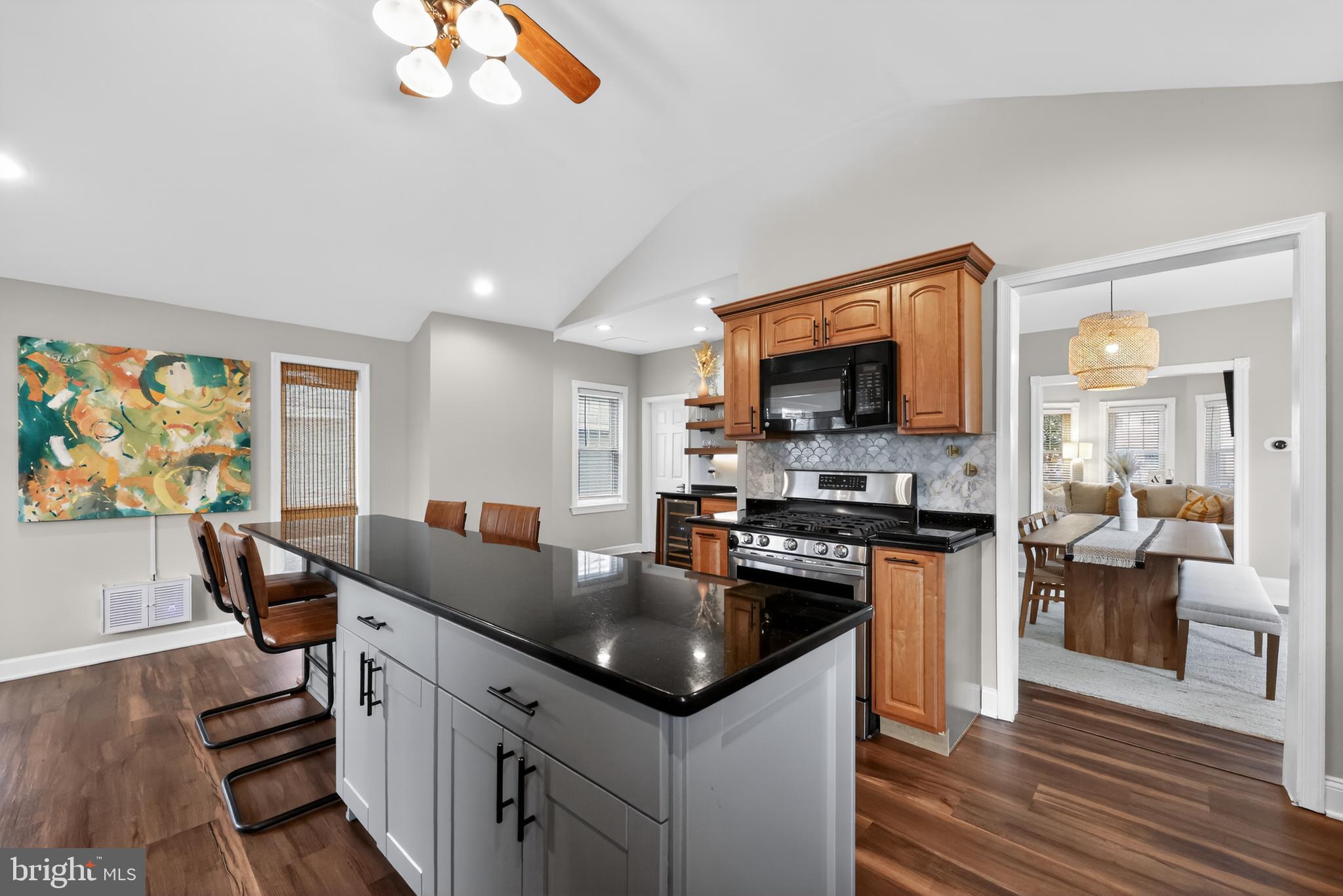208 Richey Avenue Collingswood, NJ 08107 - Photo 13 of 35 a kitchen with granite countertop a stove top oven a sink dishwasher a dining table and chairs with wooden floor