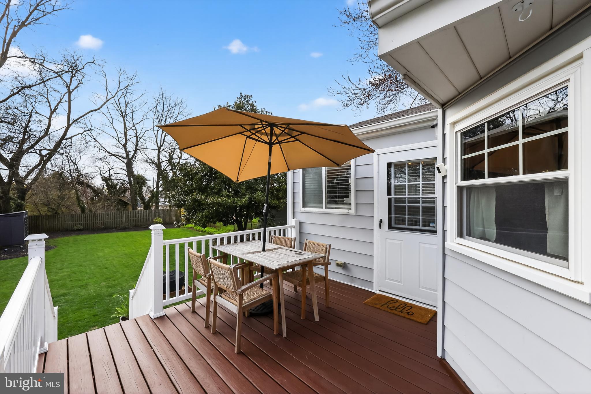 208 Richey Avenue Collingswood, NJ 08107 - Photo 32 of 35 a view of a roof deck with table and chairs under an umbrella with wooden floor and a yard