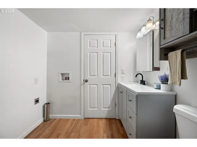 a bathroom with a sink a toilet a mirror and vanity