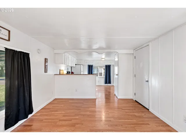 a view interior of kitchen and hall with wooden floor