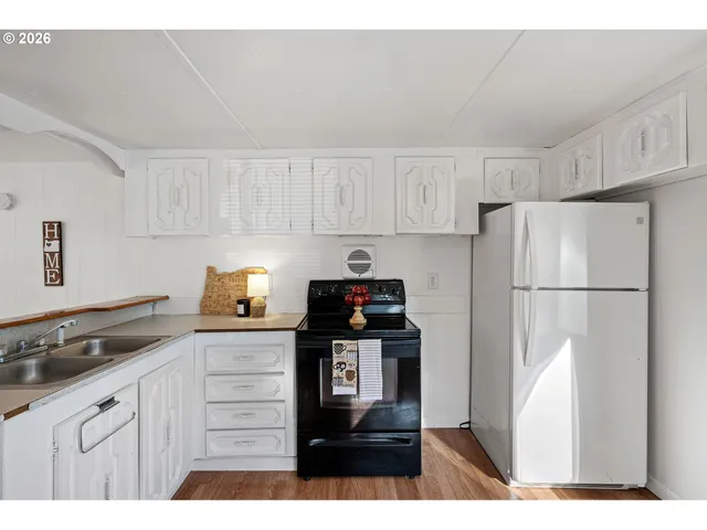 a kitchen with cabinets appliances and a counter space