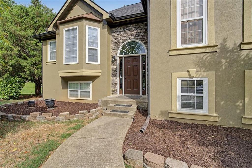 409 Windsor Way Canton, GA 30115 - Photo 4 of 51 a front view of a house with a yard
