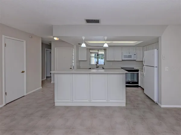 a kitchen with a sink cabinets and stainless steel appliances