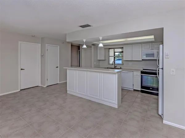a kitchen with stainless steel appliances a sink and cabinets