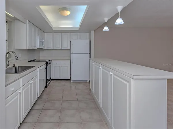 a kitchen with a sink and refrigerator