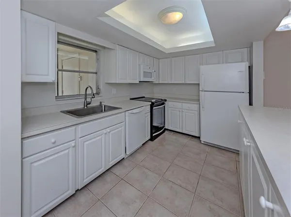 a view of a kitchen with a sink and cabinets