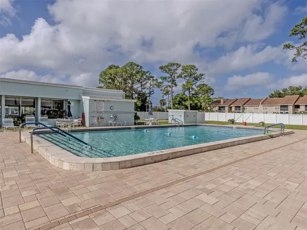a kitchen with stainless steel appliances granite countertop a stove top oven a sink and a refrigerator