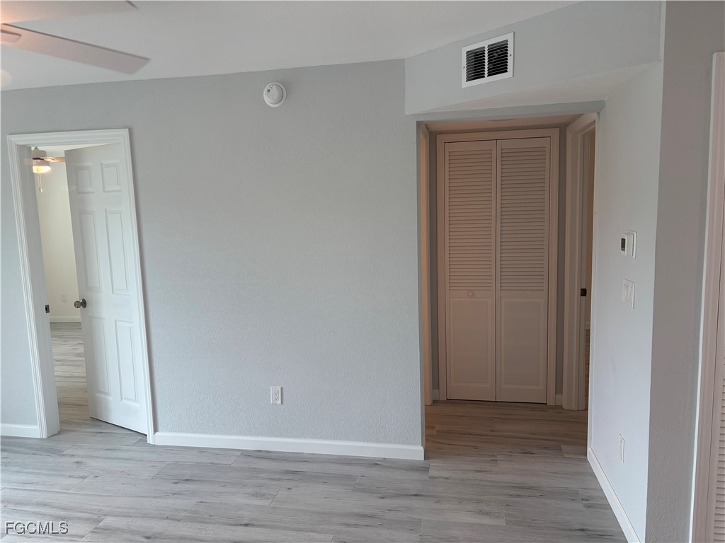 16881 Davis Road, Unit 414 Fort Myers, FL 33908 - Photo 11 of 24 a view of an empty room with wooden floor
