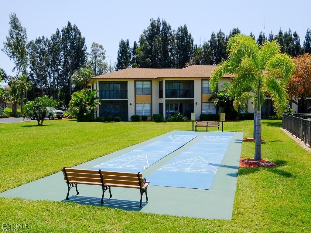 16881 Davis Road, Unit 414 Fort Myers, FL 33908 - Photo 18 of 24 a swimming pool with outdoor seating and yard