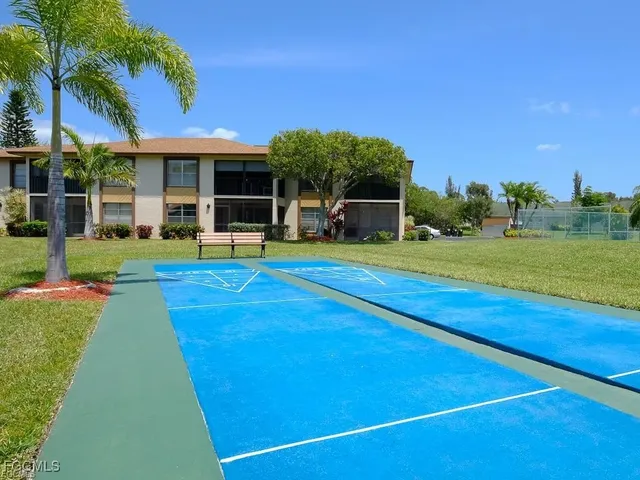 a view of pool with large windows and a yard