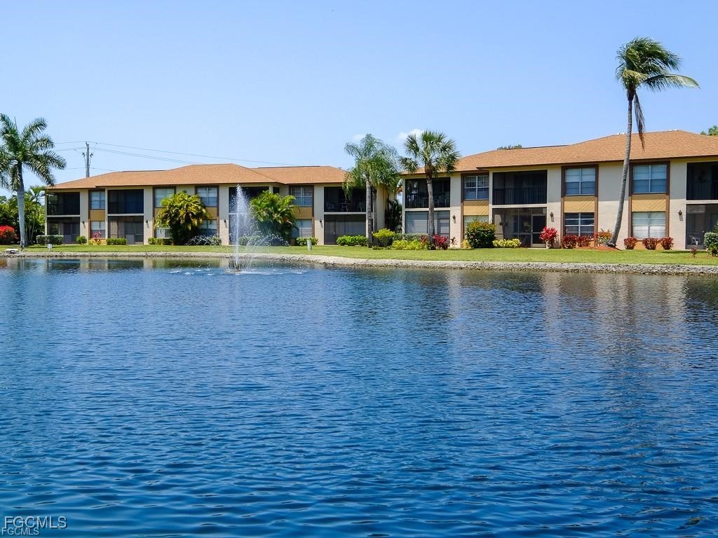 16881 Davis Road, Unit 414 Fort Myers, FL 33908 - Photo 20 of 24 a view of pool with large windows and a yard