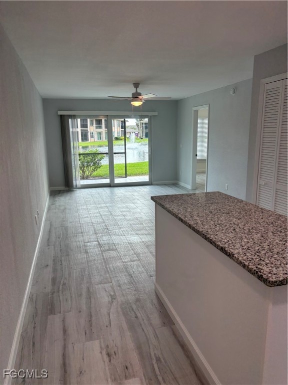 16881 Davis Road, Unit 414 Fort Myers, FL 33908 - Photo 7 of 24 a view of an empty room with wooden floor and a window
