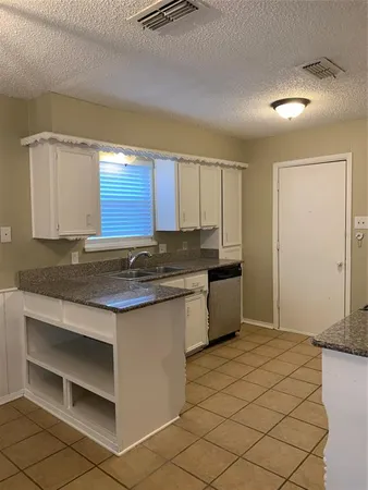 a kitchen with stainless steel appliances granite countertop a sink and a stove