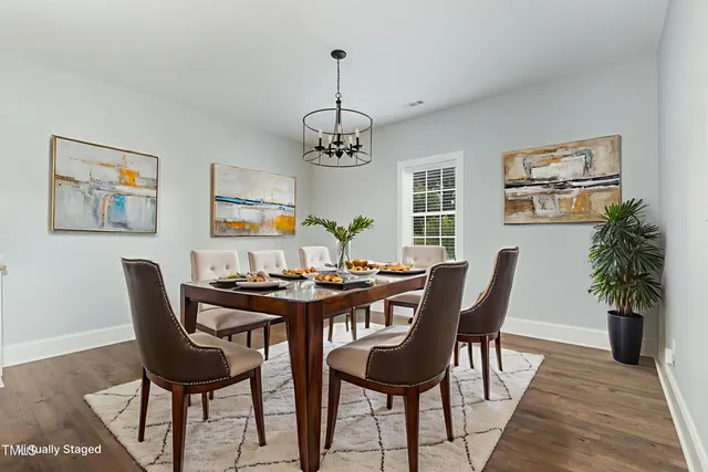 a view of a room with wooden floor air conditioner and a window