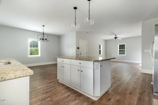 a kitchen with a refrigerator a sink a stove and cabinets