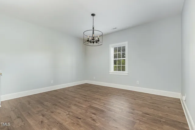 a view of a kitchen with wooden floor and a kitchen space