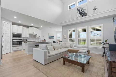 a living room with furniture and kitchen view