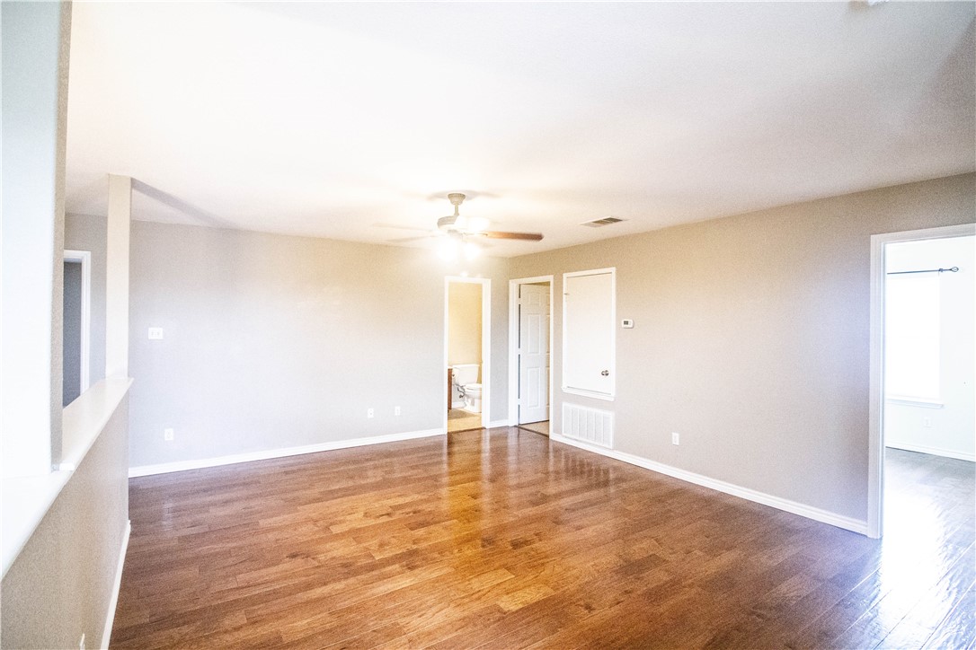 413 Moorhen Cove Leander, TX 78641 - Photo 13 of 18 a view of an empty room and wooden floor