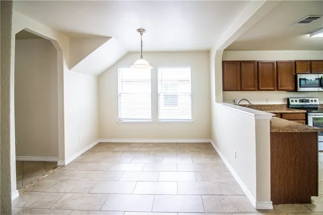 a view of a kitchen with a sink and a window