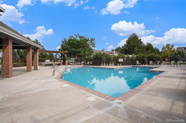 a view of a swimming pool with an outdoor space and seating area
