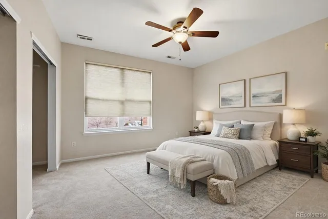 a bedroom with a large bed and a window