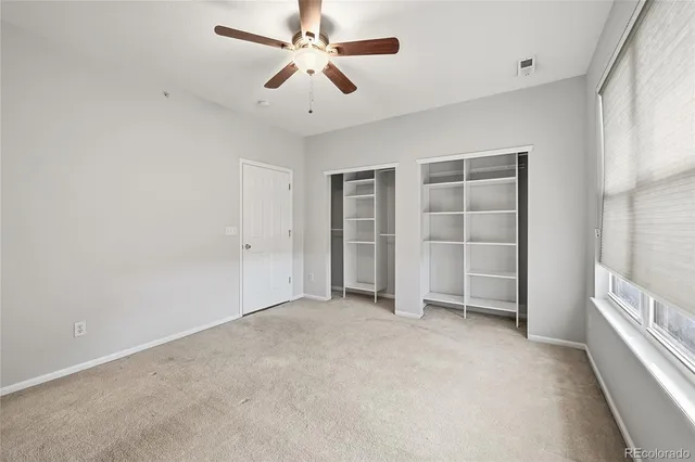 an empty room with a empty space and windows