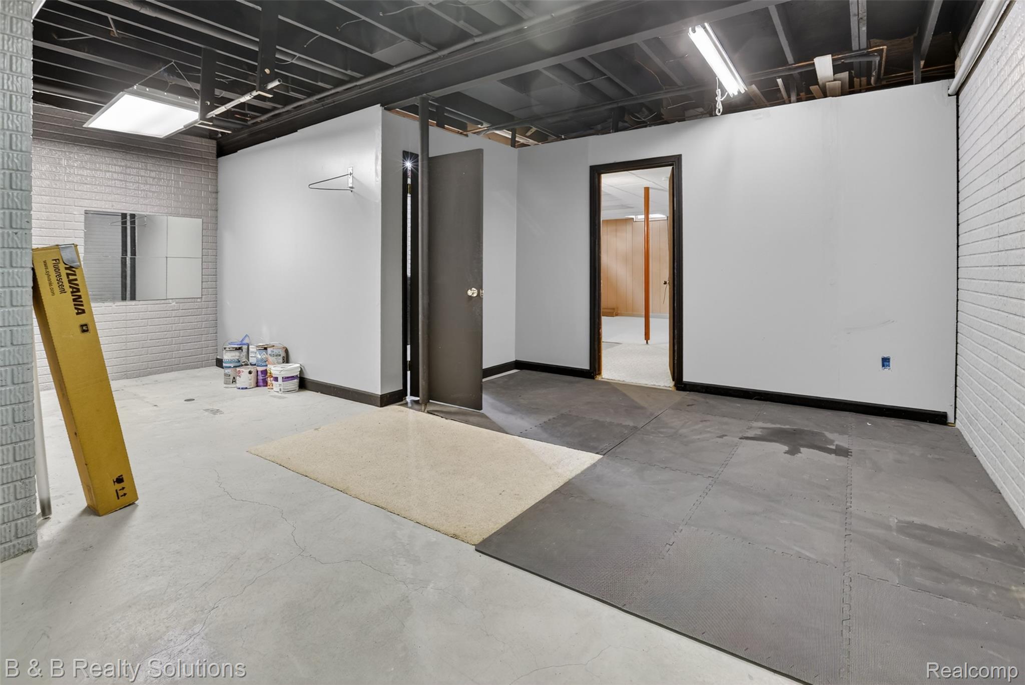 6100 Fish Lake Road North Branch, MI 48461 - Photo 29 of 45 Finished below grade area with brick wall and baseboards