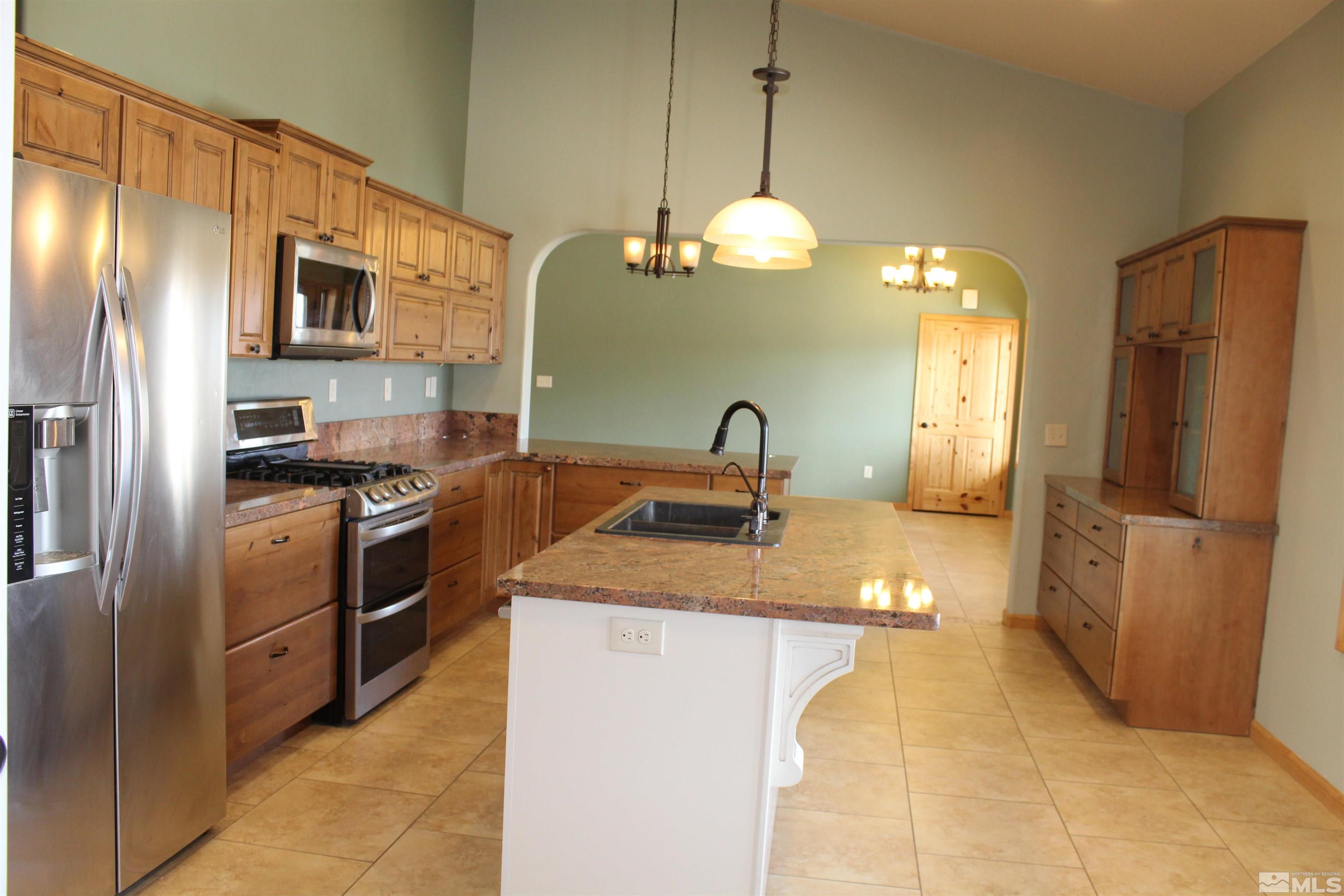 3355 Basque Oven Road Reno, NV 89510 - Photo 14 of 40 a kitchen with stainless steel appliances a refrigerator sink and microwave