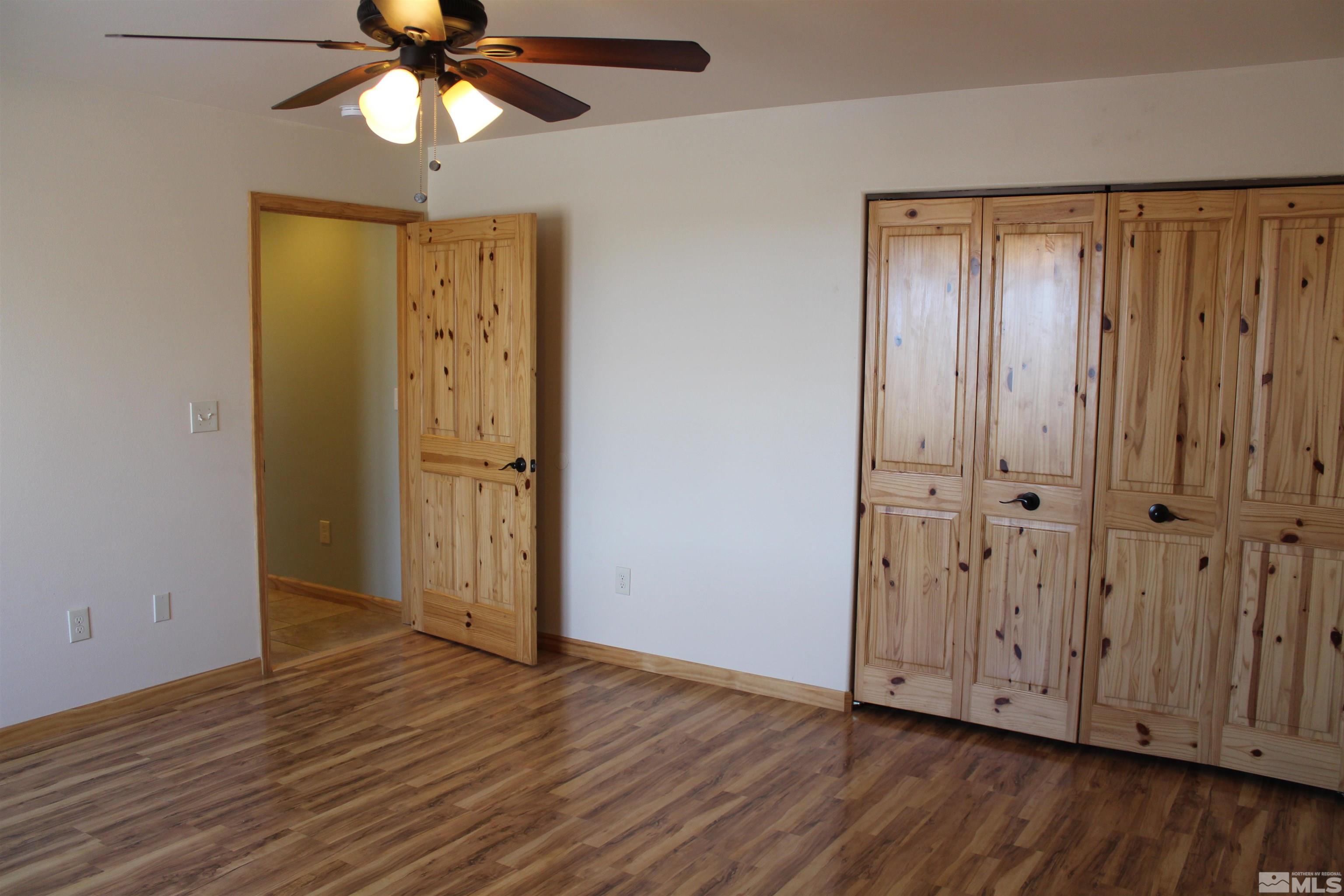 3355 Basque Oven Road Reno, NV 89510 - Photo 20 of 40 a view of an empty room with wooden floor and a ceiling fan