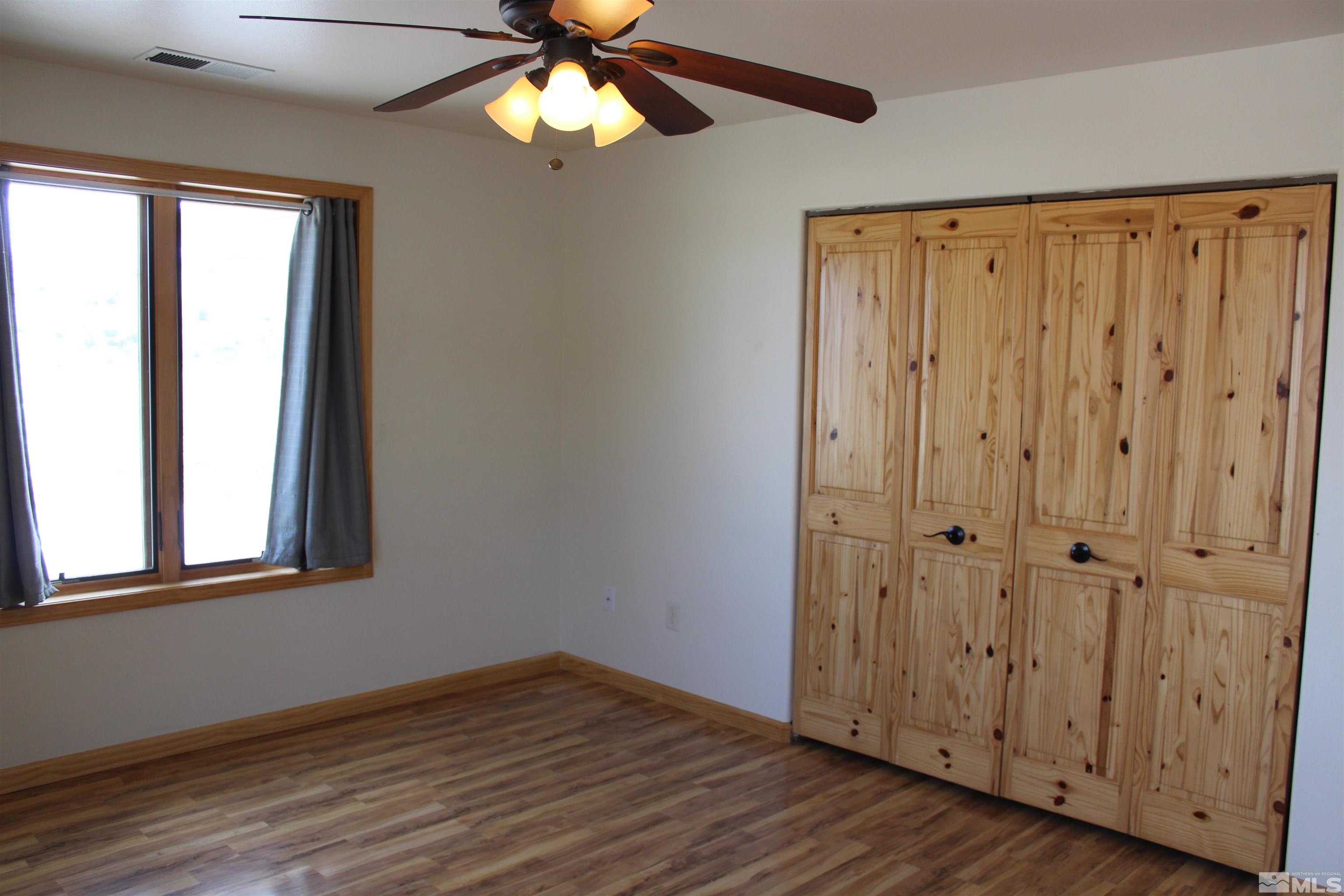 3355 Basque Oven Road Reno, NV 89510 - Photo 23 of 40 a view of an empty room with wooden floor and a window