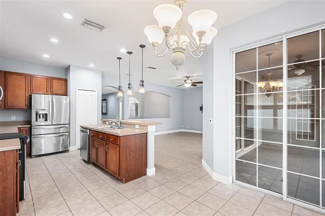 a kitchen with kitchen island granite countertop a stove a sink and a refrigerator
