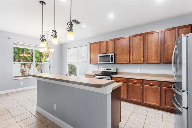 a kitchen with stainless steel appliances a sink stove and refrigerator