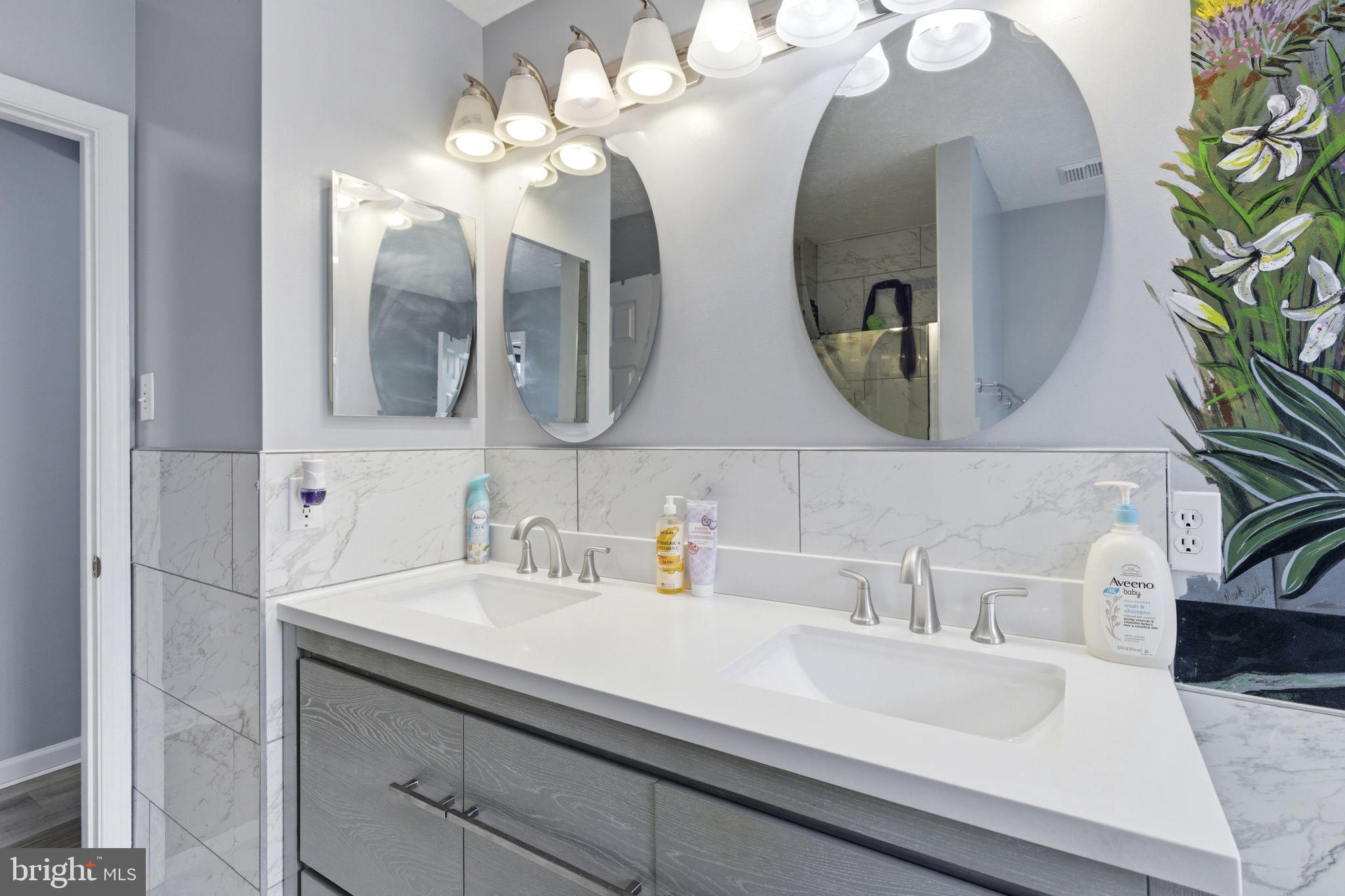 3413 Barkley Woods Road Baltimore, MD 21244 - Photo 11 of 31 a bathroom with a sink and a mirror