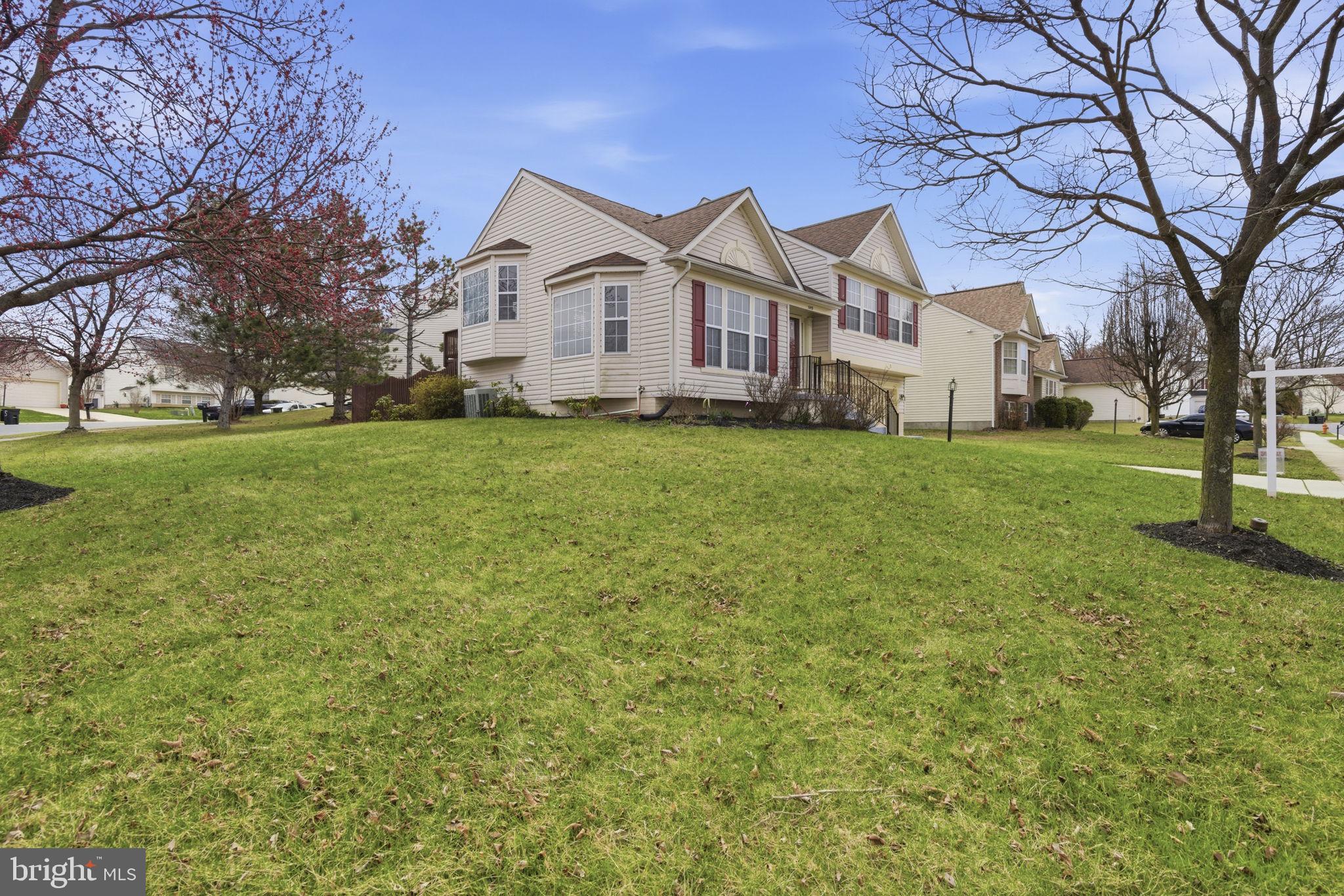 3413 Barkley Woods Road Baltimore, MD 21244 - Photo 27 of 31 a front view of a house with a garden and trees