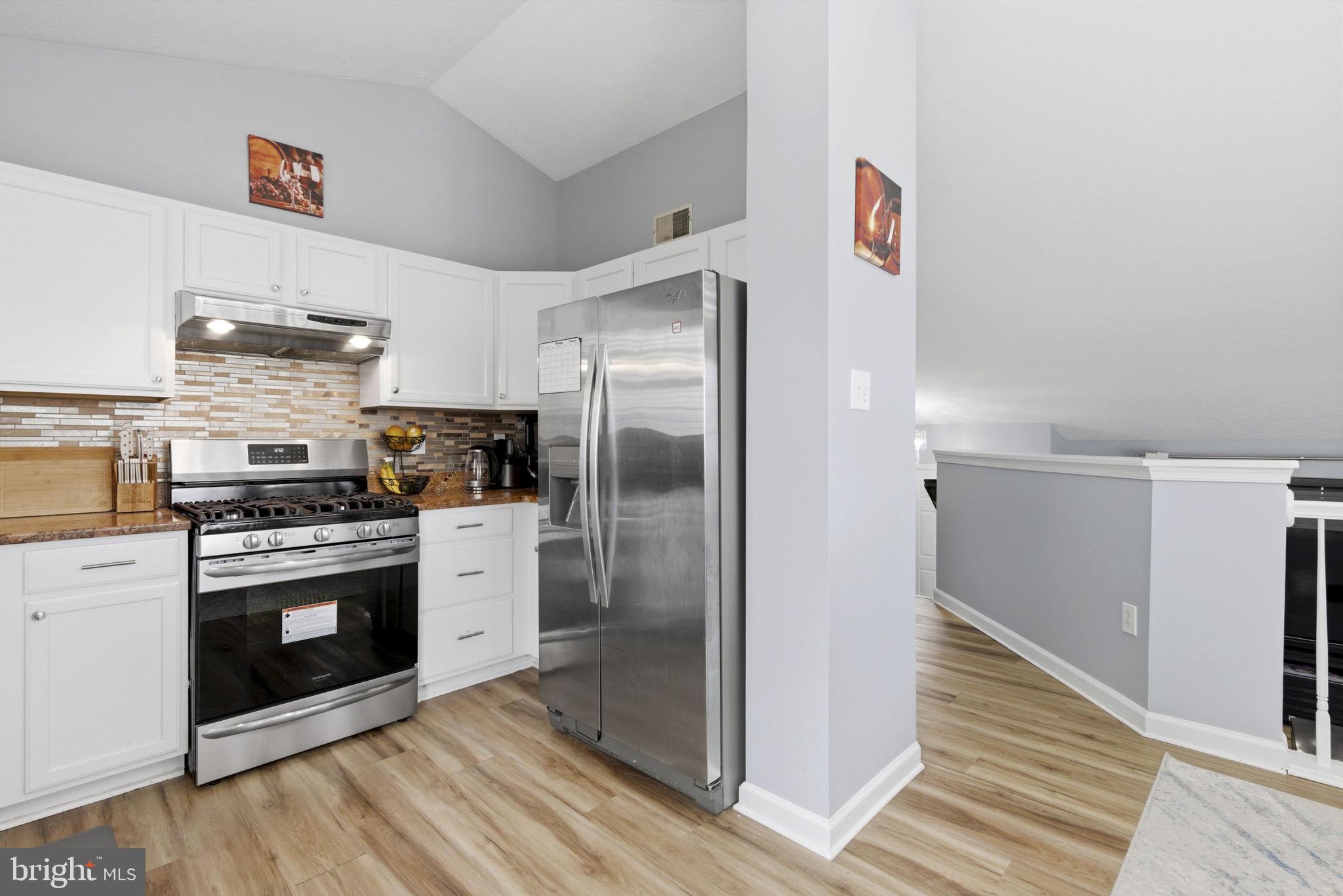 3413 Barkley Woods Road Baltimore, MD 21244 - Photo 4 of 31 a kitchen with stainless steel appliances granite countertop a refrigerator and a stove