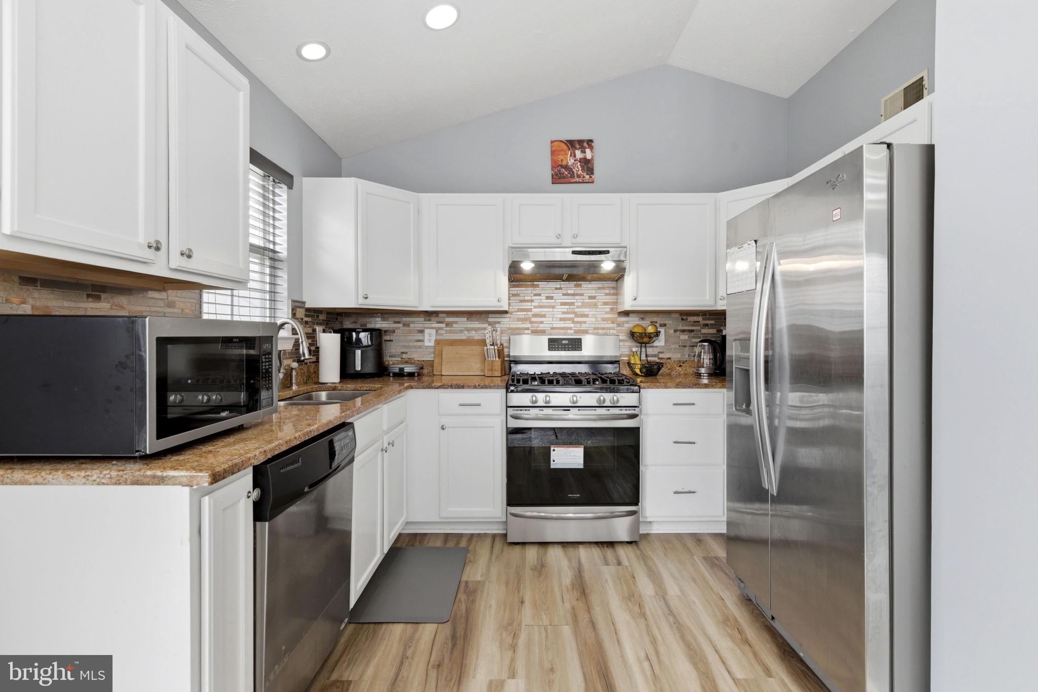 3413 Barkley Woods Road Baltimore, MD 21244 - Photo 5 of 31 a kitchen with a refrigerator sink and microwave