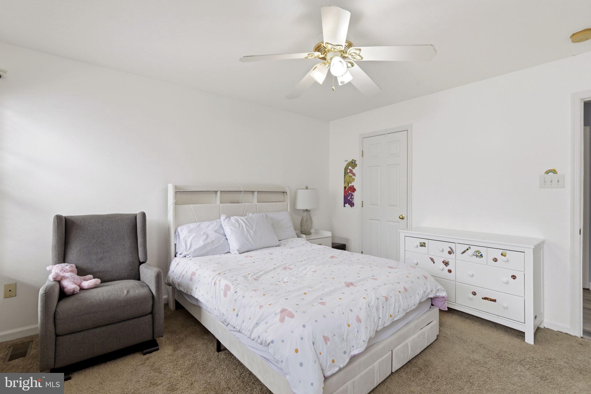 3413 Barkley Woods Road Baltimore, MD 21244 - Photo 9 of 31 a bedroom with a bed and a couch