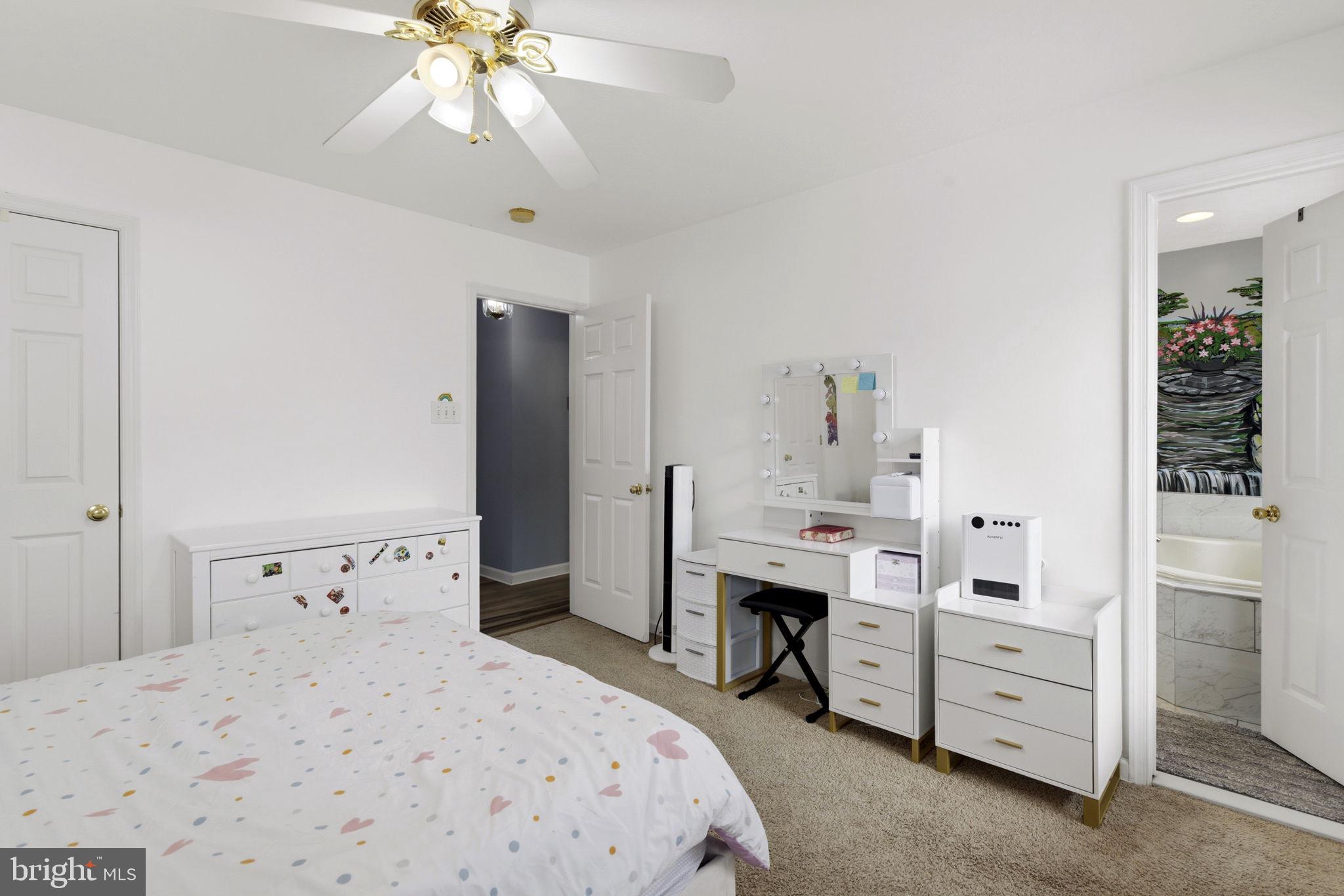 3413 Barkley Woods Road Baltimore, MD 21244 - Photo 10 of 31 a bedroom with a bed and a chandelier