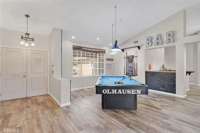 a view of a kitchen with wooden floor and window